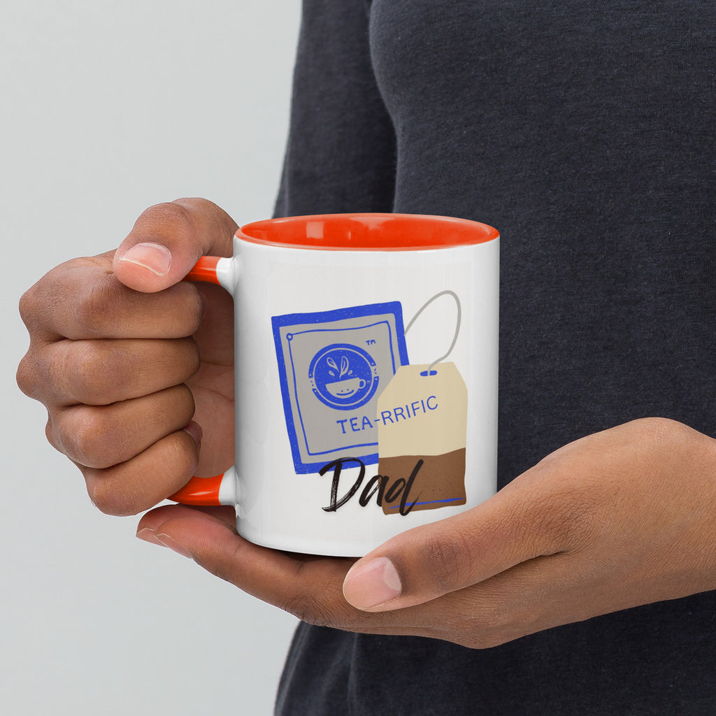 Person holding a mug with 'TEA-RRIFIC Dad' design on a plain White background.
