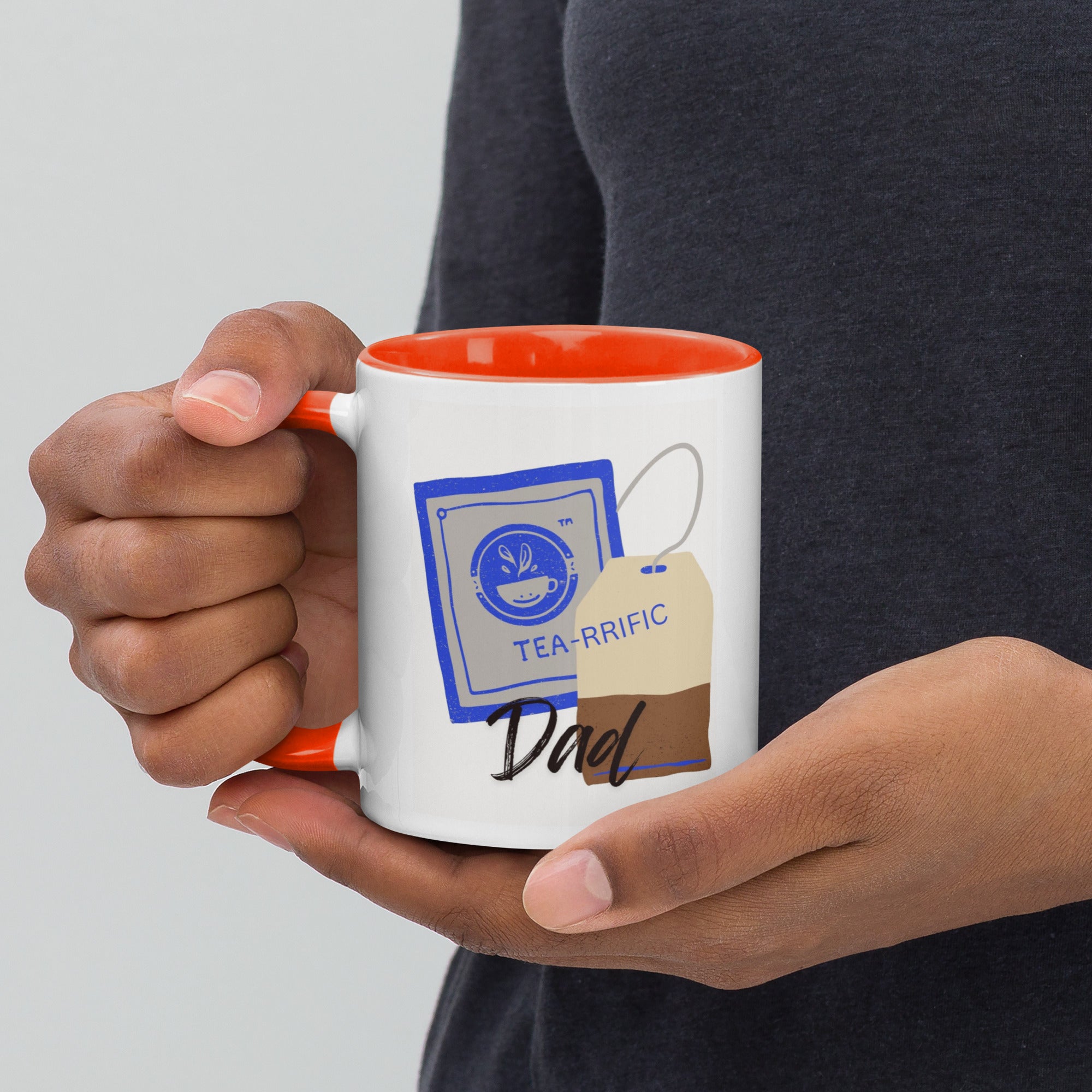 Person holding a mug with 'TEA-RRIFIC Dad' design on a plain White background.