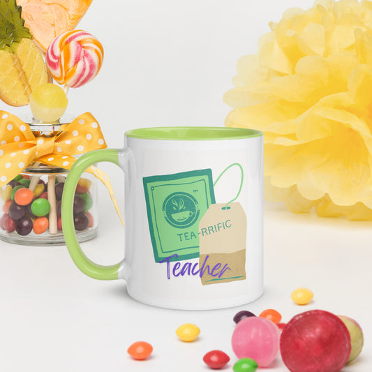 Mug with 'Tea-rrific Teacher' design surrounded by candies and flowers on a white background